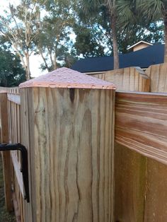 a wooden fence with an umbrella sticking out of it's top and the bottom