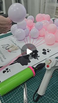 a table with balloons, scissors and other items on it that are ready to be cut