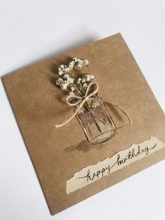 there is a card with flowers in a vase on it