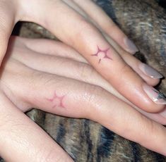 two fingers with small stars on them