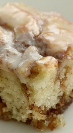 a close up of a piece of cake on a plate with frosting and icing