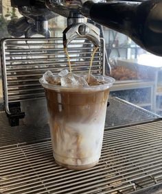 coffee being poured into a cup on an espresso machine