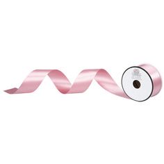 a roll of pink satin ribbon on a white background with the word love written in it