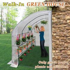 a woman standing in front of a green house