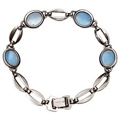 Sterling silver and moonstone link bracelet. Beautiful oval moonstone cabochons alternating with thin silver oval open links. Measures approx 7 1/2" long end to end, 7 1/4" on cone, 3/8" wide, sits 6mm high. Stones measure approx 11mm x 9mm, oval links measure approx 7mm wide. Weighs 12.9g, 8.3dwt. Marked STERLING WRE Link Bracelets, Turquoise Bracelet, Moonstone, Jewelry Bracelets, Charm Bracelet, Turquoise, Bracelet, Sterling Silver, Stone