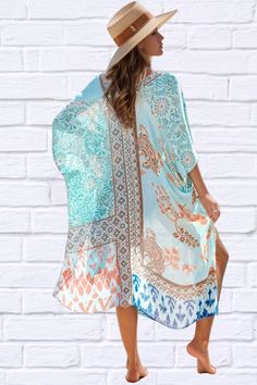 Introducing our Printed Open Front Cover-Up Kimono, a must-have addition to your beachwear collection. Crafted with lightweight fabric and featuring a vibrant printed design, this kimono adds a touch of elegance and flair to any swimwear ensemble. With its open front style, it effortlessly drapes over your shoulders, providing just the right amount of coverage while still allowing your swimsuit to peek through. The loose and flowy fit ensures comfort and breathability on hot summer days. Perfect V-neck Patterned Kimono For Festival, Vacation Beach Cover-up Kimono With Kimono Sleeves, Multicolor Summer Kimono For Beach Cover-up, Floral Print Open Front Cover-up For Vacation, Summer Floral Print Wrap Cover-up, Casual Multicolor V-neck Kimono, Beachy Printed Pool Cover-up, Printed Beach Cover-up With Kimono Sleeves, Casual Patterned Kimono For Beach Cover-up