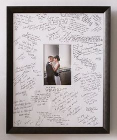 a couple is holding each other in front of a wall with writing on it