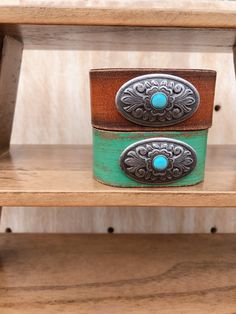 Turquoise Centered Concho On Handpainted Leather Bracelet The turquoise centered concho on handpainted leather bracelet is one of our store's best sellers. Featured with a silver concho with a turquoise in the center, this bracelet is going to stand out on your wrist! Perfect to match with your western boho vibe outfit. Measurements: 1" width Closure: Snap Color: Turquoise Western Boutique, Hand Painted Leather, Jewelry Turquoise, Color Turquoise, Cool Store, Western Boho, Boho Vibe, Turquoise Jewelry, Leather Bracelet