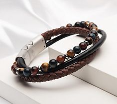 Elevate your laid-back style with this multistrand leather and tiger's eye look. From Verve. Masculine Accessories, Masculine Braided Leather Bracelet For Gift, Viking Jewelry Mens Leather Bracelet, Men’s Braided Leather Bracelet, Doily Crafts, Tiger Eye Necklace Men, Mens Jewerly, Masculine Brown Leather Braided Bracelet, Mens Bracelets