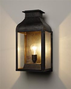 an outdoor wall light with a bulb on it