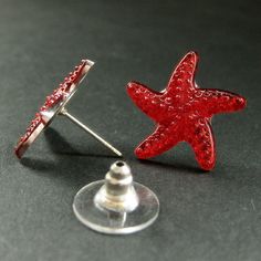 Red Starfish Earrings with Silver Post Earrings Back. Sparkly little red starfish have been set on silver plated post earrings complete with matching earring backs in this pair of handmade earrings. These earrings are available in a variety colors! http://etsy.me/1DuDuC3 Starfish Size: 19mm [Starfish are transparent plastic with a silver tone backing.] If you would like to order a larger quantity than what's offered in this listing, please contact me for availability! Stop by and visit http://st Red Star-shaped Earrings For Party, Red Star-shaped Party Earrings, Red Star-shaped Nickel-free Earrings, Nickel-free Red Star Earrings, Starfish Earrings, Earring Backs, Ring Holder, Matching Earrings, Handmade Earrings