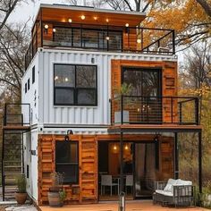 a house made out of shipping containers in the woods