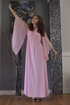 This gorgeous 1970s pink maxi dress features beautiful sheer angel sleeves, a v-neckline and lace with rhinestones on the waistline. It has a back zipper closure. Very boho chic and flowy! Brand: N/A Decade: 1970s Size: Women's Small (see photos for measurements) Condition: Very good *ALL ITEMS ARE FINAL SALE AND COME FROM A SMOKE FREE HOME. ITEMS MAY HAVE SCUFFS, ODORS, STAINS/MARKS OR HOLES. I DO NOT INSPECT ANY ITEMS SOLD UNLESS INDICATED IN PHOTOS OR DESCRIPTION. ALL ITEMS ARE PURCHASED AS IS AND ARE SOLD AS IS.* 70s Light Pink Dress, 70s Fashion Women, Angel Sleeve Dress, Matching Skirt Set, Angel Sleeves Dress, Pink Angel, 70s Outfits, Angel Sleeves, Simple Prom Dress