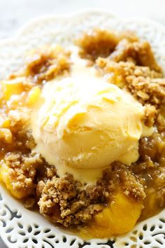 a white plate topped with an apple crumble and ice cream on top of it