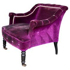 an upholstered purple chair with black legs