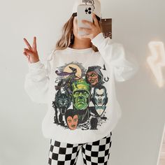 This Halloween Monster Shirt has a Vintage Halloween vibe and a fun Monster Mash themed graphic. Celebrate Spooky Season with a cute Fall sweatshirt that you will want to wear on repeat. This is a relaxed fit unisex sweatshirt, but true to size. We recommend sizing up if you want a trendy oversized look. - M A T E R I A L S - Gildan® Sweatshirt 8 oz./yd² (US) 50/50 cotton/polyester Heather Sport colors: 60/40 polyester/cotton Loose Fit Ribbed Knit Collar to retain shape - C A R E  I N S T R U C Halloween Themed Streetwear Tops, Halloween Pop Culture Tops With Character Print, Pop Culture Halloween Tops With Character Print, Themed Long Sleeve Sweatshirt With Character Print, Themed Long Sleeve Fan Merchandise Tops, Themed Long Sleeve Tops With Graphic Print, Themed Crew Neck Top For Costume Party, Pop Culture Tops With Character Print For Fall, Themed Long Sleeve Tops With Cartoon Print