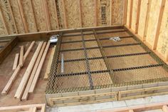 the inside of a house being built with wood and wire mesh fencing on the floor