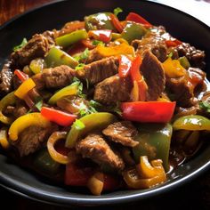 a black plate topped with meat and peppers