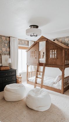 a child's bedroom with two bunk beds and a large white bean bag chair