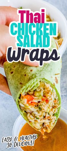 the chicken salad wrap is being held up by someone's hand over a bowl of soup