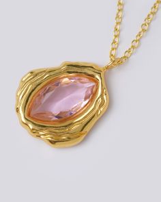 Introducing our exquisite Elle Gold Pendant, an embodiment of elegance and sophistication. At its heart lies a magnificent large Natural Pink Quartz, captivating the eye with its mesmerizing allure. Its unique shape gracefully imitates the delicate dance of a crystal melting in hot lava, or the sublime contours of a glistening vulva, symbolizing both strength and sensuality. Designed to seamlessly transition from day to night, this pendant is a versatile statement piece that effortlessly complem Tailored Jeans, Unique Statement Necklace, Sun Sets, 24kt Gold, Statement Pendant, Pink Quartz, Pink Stone, Evening Attire, In Hot