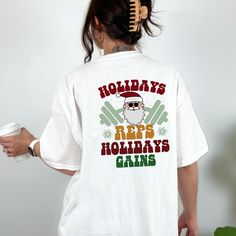 "COPY AND PASTE THIS URL INTO YOUR BROWSER TO GRAB YOUR FREEBIE https://thelftshop.ck.page/04aec3840a Introducing our \"Holidays Reps, Holidays Gains\" T-Shirt - the perfect attire for those who understand that the holiday season is no reason to take a break from fitness. This isn't just a T-shirt; it's a festive declaration that holidays are a time for both celebration and gains. Key Features: 1. Premium quality fabric: Our T-shirt is made from a soft and breathable blend of cotton and polyester, ensuring maximum comfort and durability. 2. Unisex fit: This T-shirt is designed to fit both men and women comfortably, offering a relaxed and flattering silhouette. 3. Available sizes: We offer a range of sizes from S to 5XL, so you can find the perfect fit that suits your body type. Care Instru Christmas Gym, Gym Tshirt, Muscle Mommy, Hour Workout, Gym Gifts, Vip Club, Pump Cover, Gym Shirt, Gym Shirts