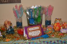 a table topped with lots of candy and lollipops