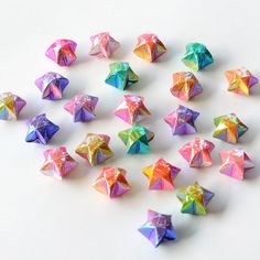 there are many different colored origami pieces on the table