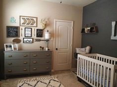 a baby's room with a crib, dresser and pictures on the wall