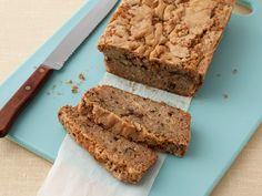 two slices of banana bread sitting on top of a blue plate next to a knife