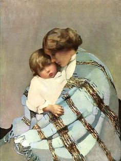 a woman holding a child wrapped in a blanket