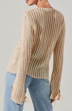 Lightweight and breezy, this semisheer sweater takes its cues from vintage styles with ladder-stitch stripes and a pair of ties in front. Front tie closure V-neck Long sleeves 89% viscose, 11% nylon Dry clean Imported Spring Striped Long Sleeve Knit Top, Fine Knit Striped Tops For Spring, Spring Striped Stretch Sweater, Striped Long Sleeve Open Knit Sweater, Striped Open Knit Long Sleeve Sweater, Chic Striped Sweater For Spring, Striped Textured Knit Top For Spring, Spring Striped Knit Top For Layering, Striped Sweater For Spring Layering