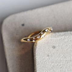 Its wavy design radiates with dazzling cubic zirconia stones of different sizes and is stackable, allowing you to mix and match the pieces to create the perfect look. -stainless steel, gold plated Wavy Gold Rings For Gift, Minimalist 14k Gold Wavy Jewelry, Minimalist 14k Gold Wavy Ring, Wavy 14k Gold Rings, Gold Wave Ring, Teeth Jewelry, Writing Accessories, Cz Ring, Bag Dress