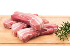 raw pork chops on a cutting board with rosemary sprig stock photos and images