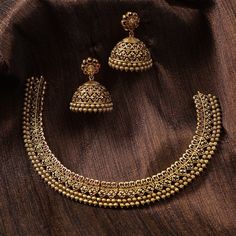 Description This antique necklace set by Tarinika is designed for someone who likes simple Indian jewelry. The necklace is crafted with geometric patterns and CZ stones on an antique gold-plated finish. It comes with traditional Jhumki style earrings which can be worn alone. Style this beautiful CZ patterned necklace set on your favorite ethnic outfit. Details & Specifications: Materials used: Brass Alloy with Antique Plating Weight – Necklace 43 gm, Earrings 25 gm Length – Necklace 12 cm, Earri Gold With Stones Necklace, Gold Set For Women, Traditional Necklace Designs Gold Indian, Vintage Indian Gold Jewellery, Jewelry Accessories For Wedding, Minimalist Indian Jewelry, Indian Simple Jewellery, Trending Jewellery Designs, Simple Gold Jewelry Indian