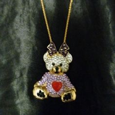 This Is A Large Gold Toned Alloy Pendant Shaped Like A Teddy Bear Dressed In A Purple Heart Sweater With A Big Purple Box On Top Of Her Head. Her Fur And Sweater Are Encrusted With Sparkling White And Purple Rhinestones. Her Heart, Bow, And Other Features Are Done In An Enamel Overlay. She Comes On A Long, Thick, Gold Toned Alloy Chain That Falls Mid Chest. New With Tags. Cute Purple Jewelry For Party, Cute Purple Party Jewelry, Purple Necklaces For Valentine's Day Party, Purple Necklace For Valentine's Day Party, Gold Seashell Necklace, Teddy Bear Pendant, Xo Necklace, A Teddy Bear, Bear Pendant