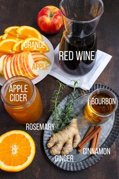 an apple cider, oranges and cinnamon on a table with labels for different types of wine