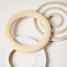 three white and beige rings are on top of each other