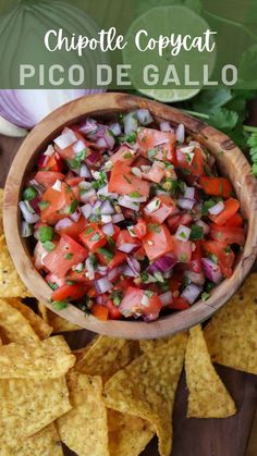 a wooden bowl filled with salsa and chips