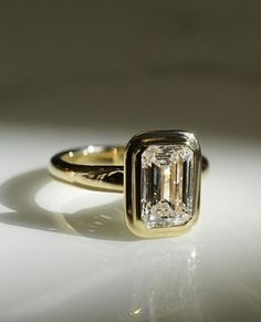 a close up of a ring with a diamond on it's center and side