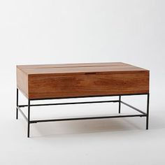 a coffee table with an open drawer on top