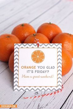 oranges are piled on top of each other with a sign that says orange you glad it's friday