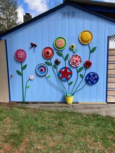 a blue shed with flowers painted on the side