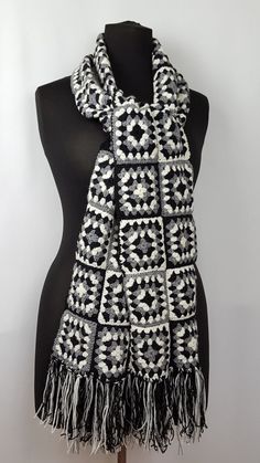 a black and white scarf on a mannequin