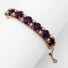 "Vintage 14 K (.585) yellow gold hinged cuff bracelet, decorated with oval cut Amethyst stones and Pearls. It has a box type closure with safety chain. This splendid bracelet is 6 5/8\" long (inside circumference), 7/16\" wide and weighs 27.9 grams. The stones measure 10 mm x 8 mm. EA983" Elegant Jubilee Amethyst Bracelets, Yellow Gold Bracelets With Amethyst Gemstone, Elegant Amethyst Jubilee Bracelet, Purple Amethyst Cuff Bracelet Gift, Luxury Elegant Amethyst Cuff Bracelet, Angel Crystal, Pearl Cuff Bracelet, Pearl Cuff, Amethyst Stones