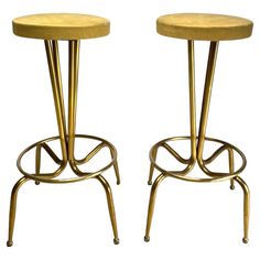 pair of brass stools with footrests on each side, in the style of art deco