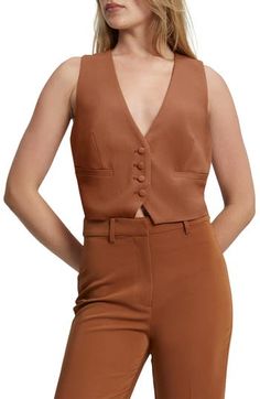 This cropped V-neck vest layers for work and wears alone for dinner. V-neck Lined 100% polyester Hand wash, line dry Imported Fitted V-neck Vest Crop Top, Brown V-neck Vest For Workwear, Brown V-neck Vest For Work, Elegant Fitted Cropped Vest, Elegant Tank Top For Fall, Chic Fitted Cropped Vest, Chic Brown V-neck Vest, Chic Cropped Tank Top, Elegant Brown Crop Top For Spring