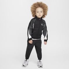 This tracksuit has style that will get your little one noticed on the playground and function that will help them stay comfy while they move. The jacket has a full-zip closure for easy layering, the standing collar adds extra coziness and the matching tapered pants have ribbed cuffs and a comfy elasticized waistband. Both pieces are enhanced with quick-drying, moisture-wicking Dri-FIT technology to help littles stay cool and dry while they play. Pair with any Nike tank or tee for a completed loo Nike Tank, Standing Collar, Tapered Pants, Stay Cool, Nike Dri Fit, Little One, Dri Fit, Moisture Wicking, Layering