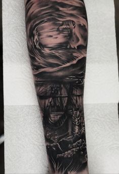 a man's arm with an image of a ship in the ocean on it