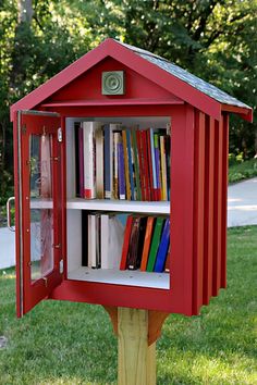 a red mailbox with books in it